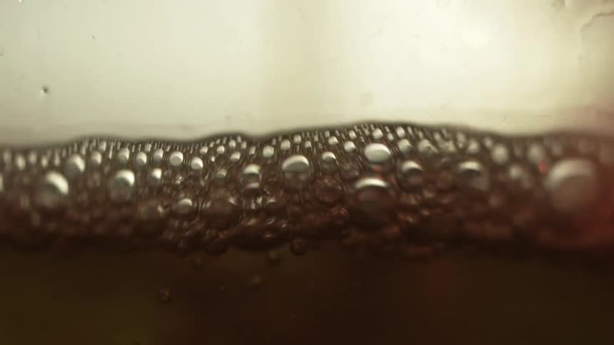 A close up of liquid filling up and bubbling
