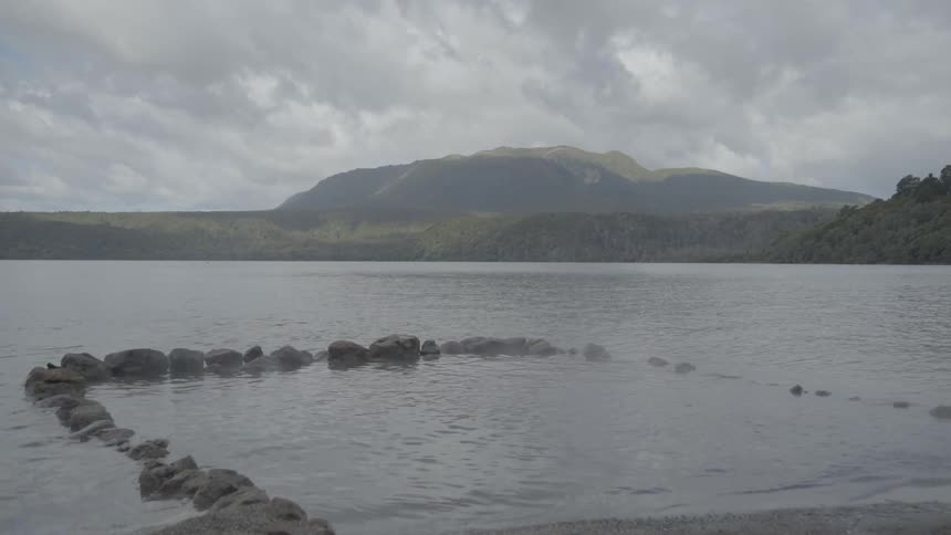 Rocks make a square in the shore of a lake