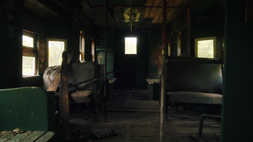 Light shines in the windows of a dusty storage room