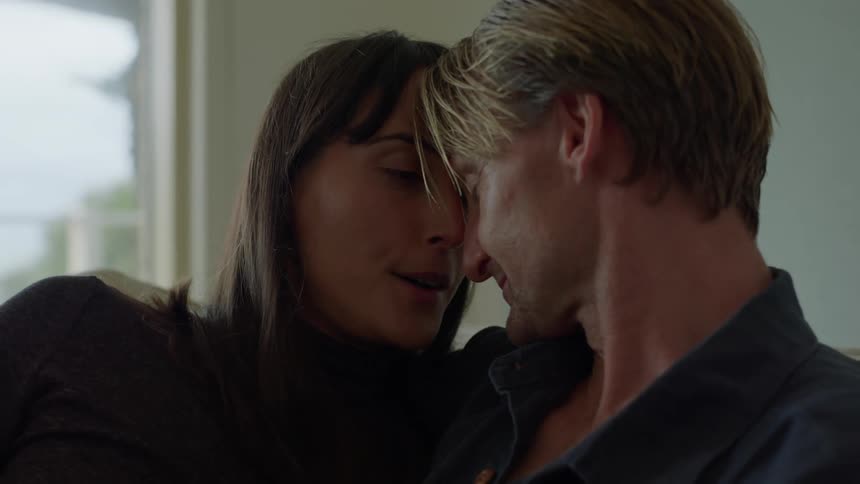 A man and woman cuddle together