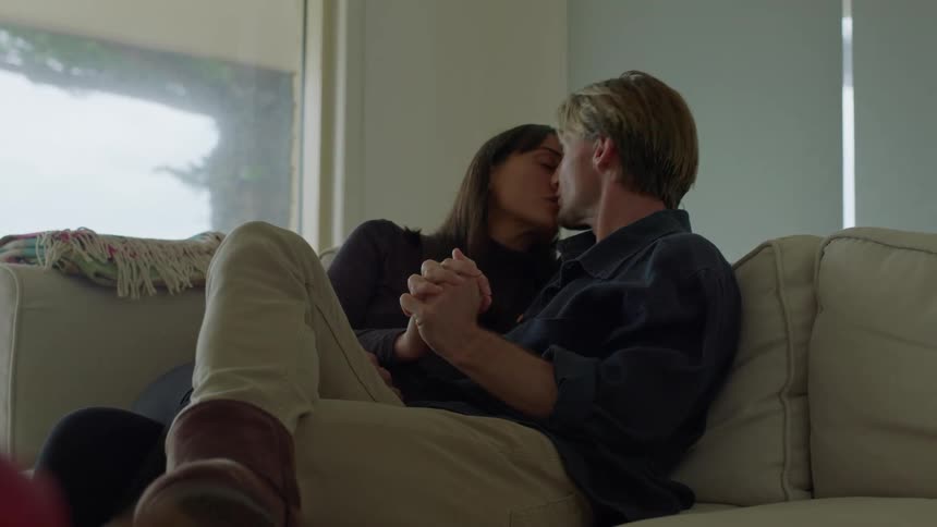 A couple on a sofa engaged in a tender moment of affection