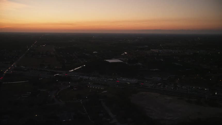 Aerial footage flying over a strip mall during twilight in Homestead Florida