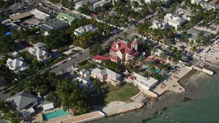 Fly over Southernmost House Historic Inn in Key West Florida a famous victorian mansion landmark of the coastline captured in aerial 5K footage