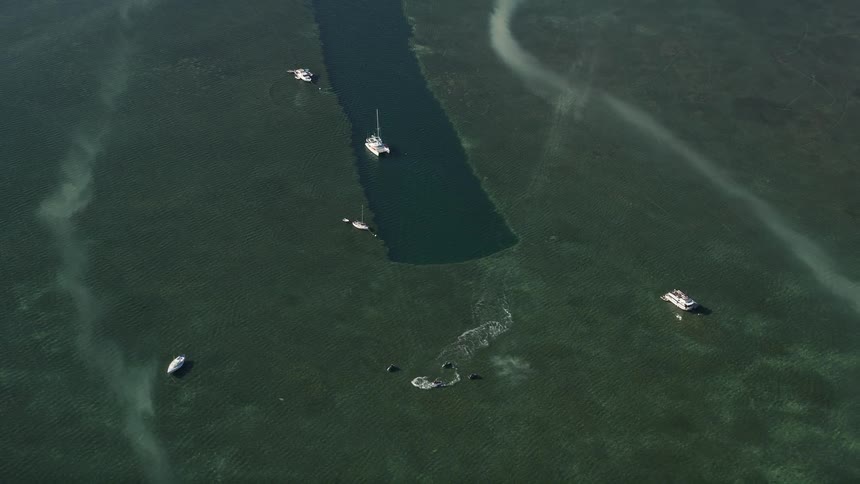 Aerial view of catamarans and jet skiers enjoying recreational activities in the ocean near Sigsbee Park Key West Florida