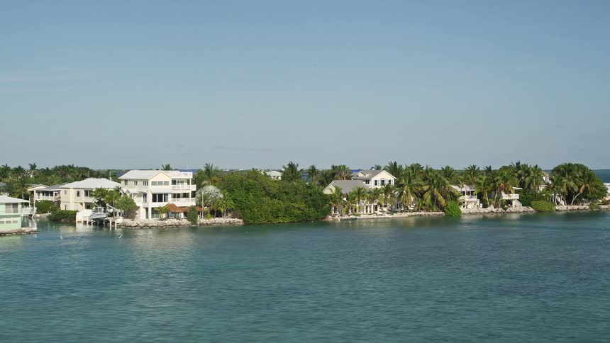 Flying over homes in a residential neighborhood on the shoreline of Summerland Key Florida