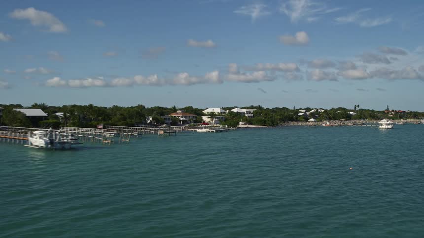 Aerial view of homes and docks along the coastline in Summerland Key Florida with beautiful blue water and lush residential neighborhoods