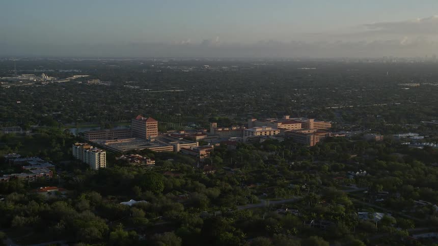 Aerial view of Baptist Hospital of Miami and surrounding medical center buildings during a partly cloudy sunrise in Kendall Florida