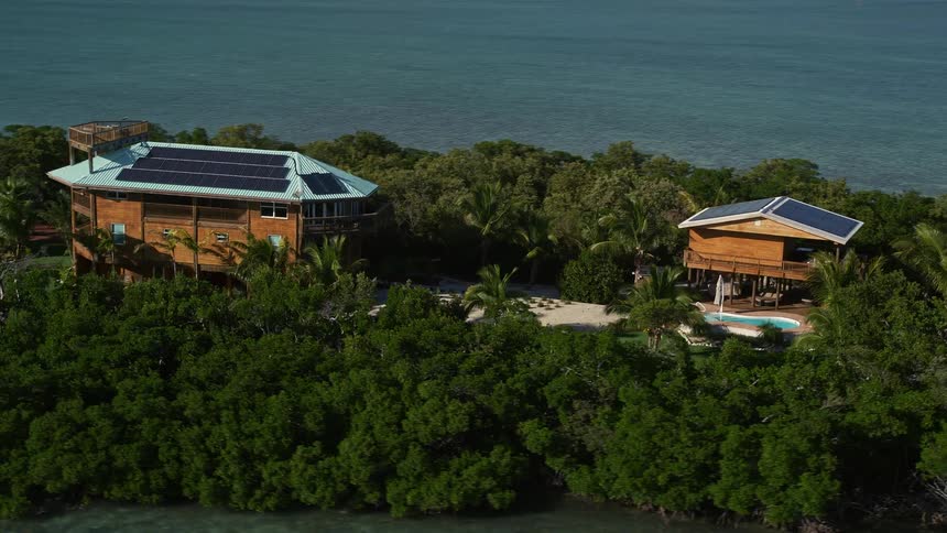 Aerial footage of a rustic house on a small island in Summerland Key Florida with a coastline and ocean views