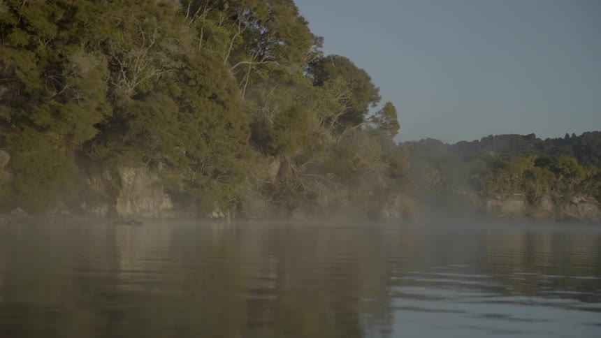 Fog rising from a body of water during the day