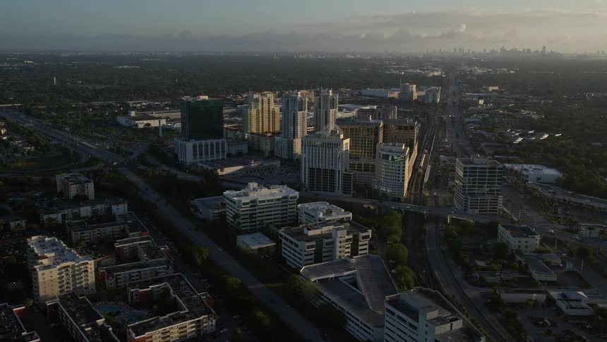 A stunning aerial view of Kendall Floridas office buildings during sunrise with partly cloudy skies and a side view approach