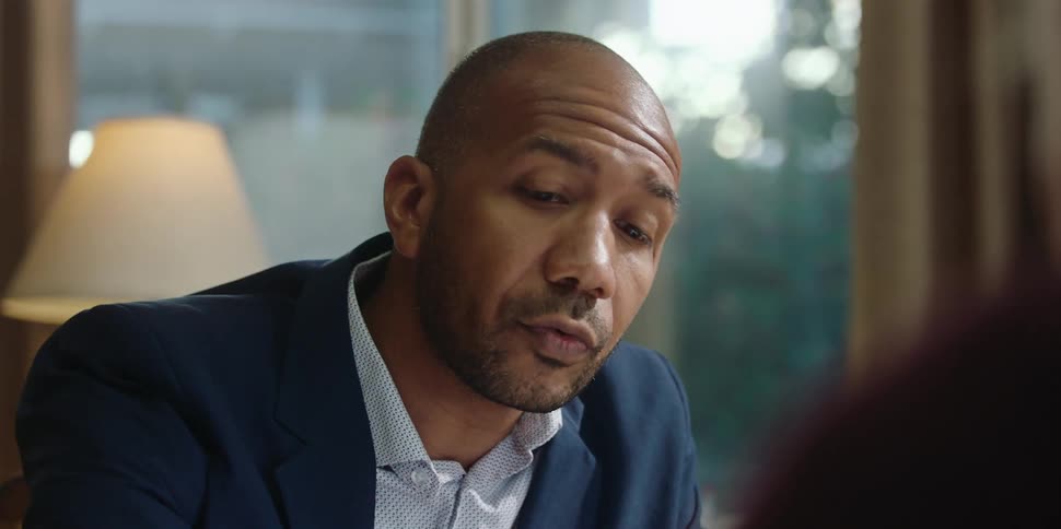 A man is talking to someone and wearing a suit