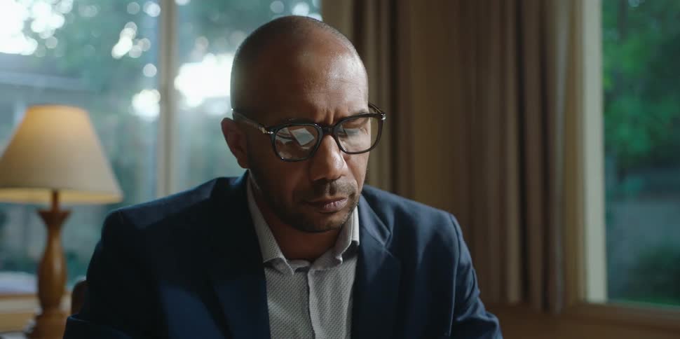 A man is sitting in his office and talking