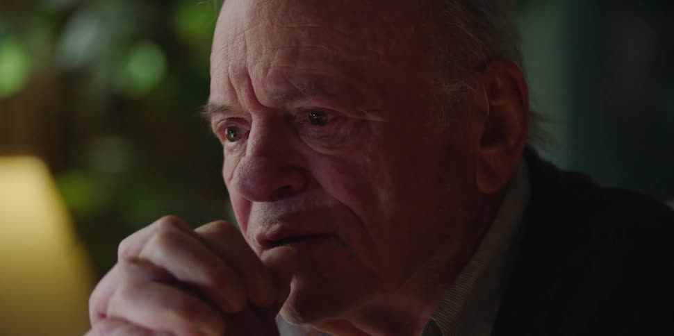 Old man grandpa sitting at dining table discussing life insurance or estate planning with someone sitting across from him