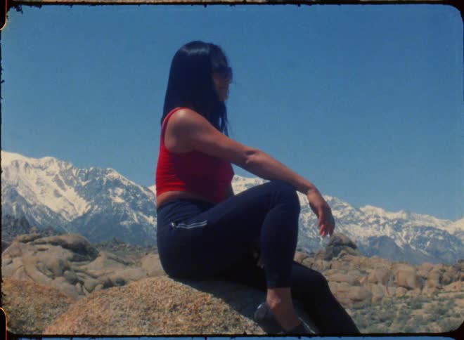 A woman is sitting on the rocks