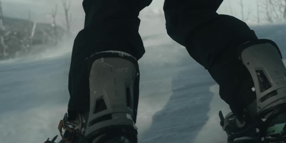 Snowboarding down a slope in a mountain range