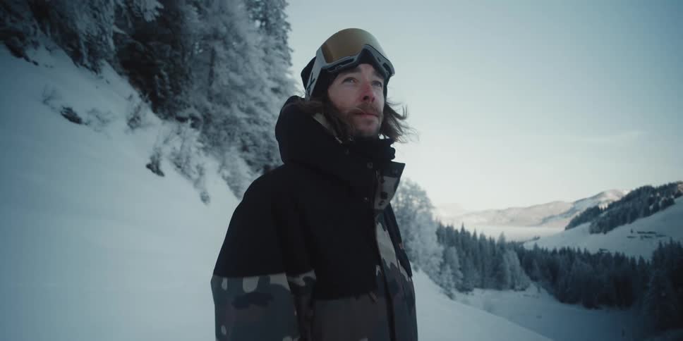 A man is holding a snowboard