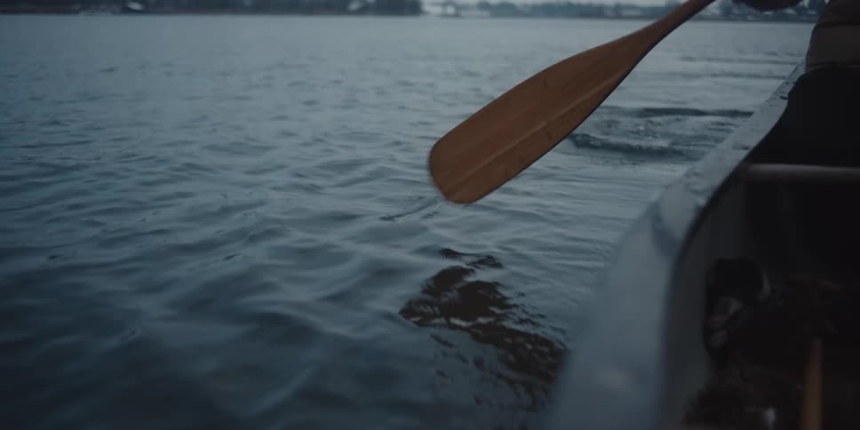 A person paddles forward a canoe