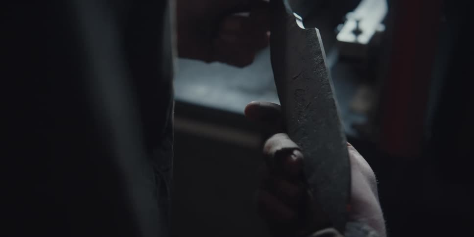 A person is examining a blade