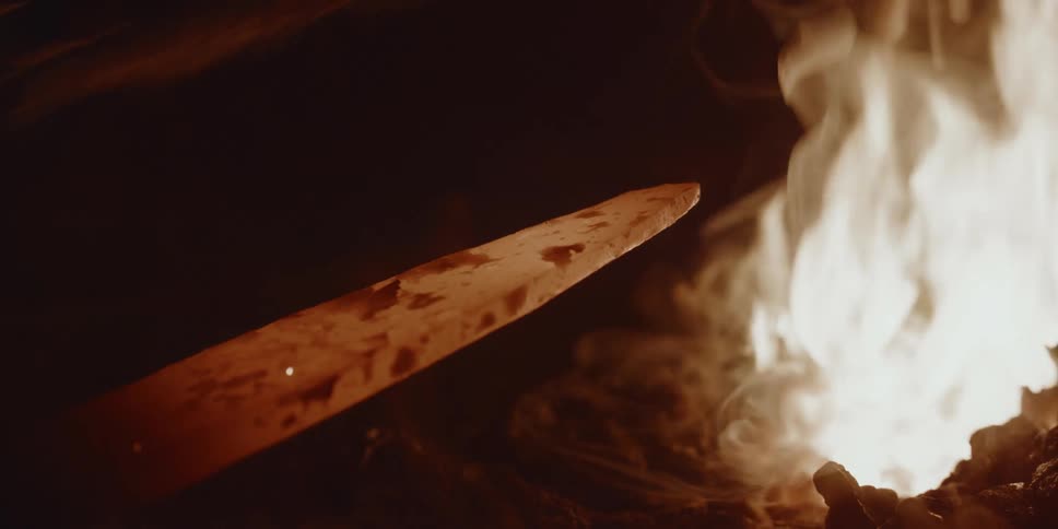 A blacksmith is forging a blade