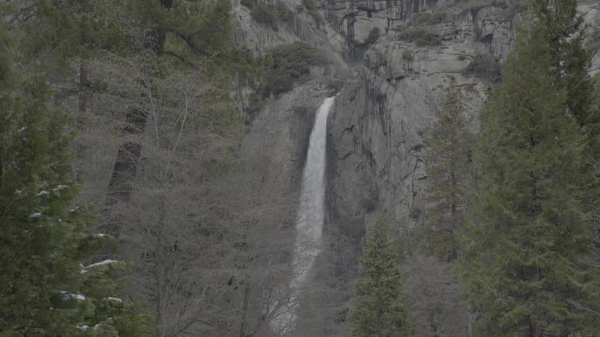 A waterfall flowing down a tall mountain