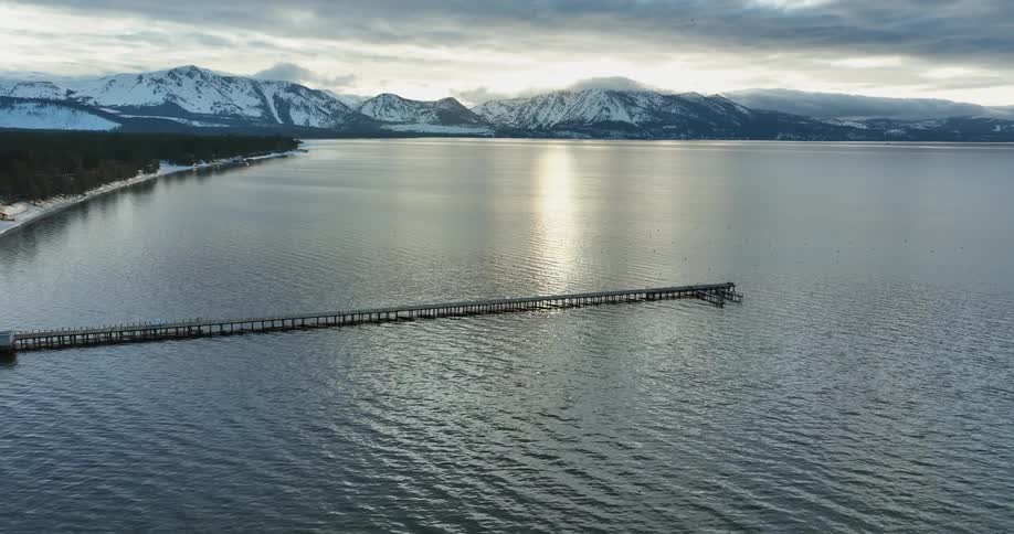Aerial view of pier ocean and snowy mountains
