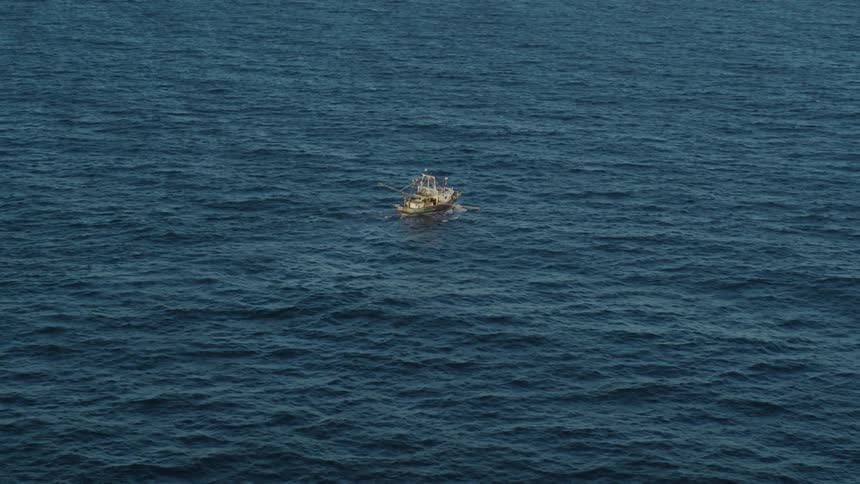 A large boat sails through the open sea