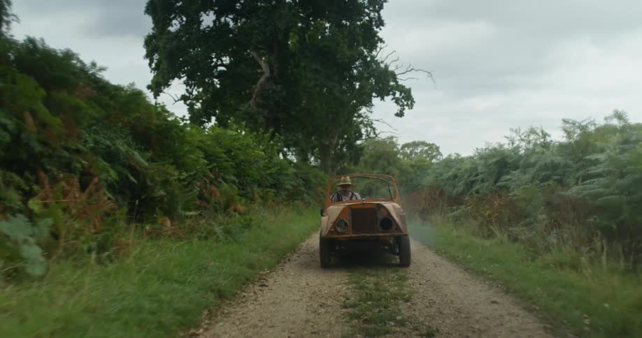 Vehicle drives along country road in the field