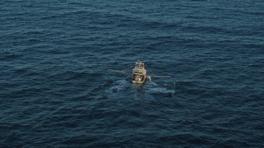 A fishing boat sailing a calm sea