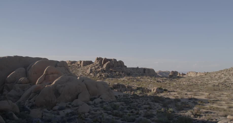 The field ahead is covered with rocks. and hills
