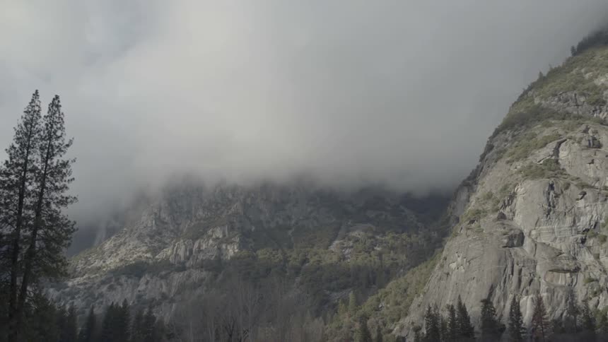 Clouds cover a mountain peak
