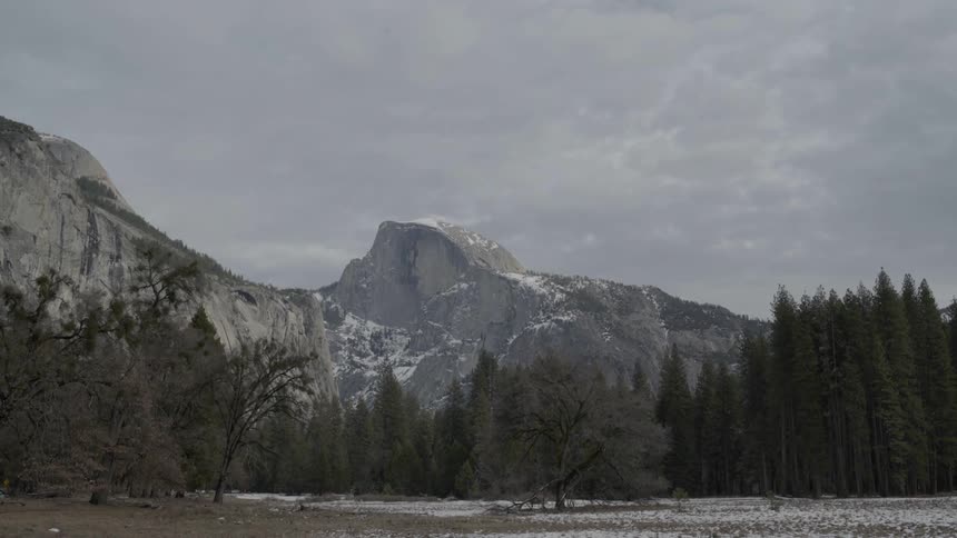 The mountains ahead are surrounded by trees
