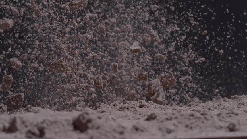 Sand shooting up in the air with a black background