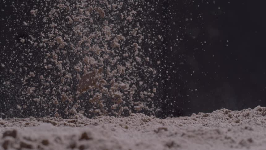 The ground explodes throwing dirt in the air