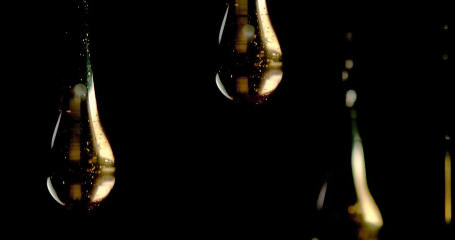 Liquid drops in front of a black background