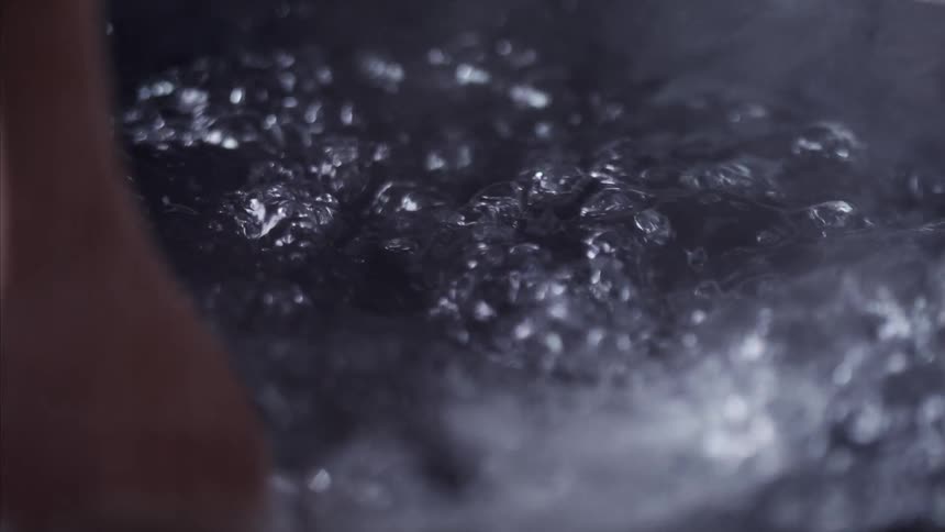 A wooden spoon goes in the water