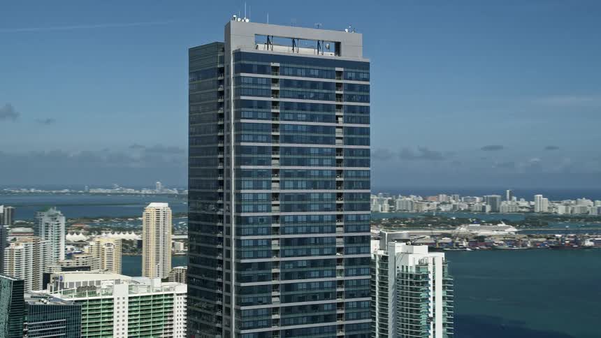 An aerial view of Four Seasons Hotel Miami a towering building in the downtown area of sunny Miami with scenic waterfront views