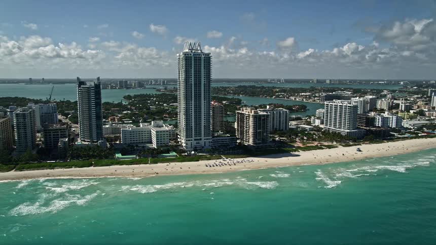 Aerial footage of Akoya Miami Beach Condo and the surrounding high rise buildings showcasing the beach and coastline of Southern Florida
