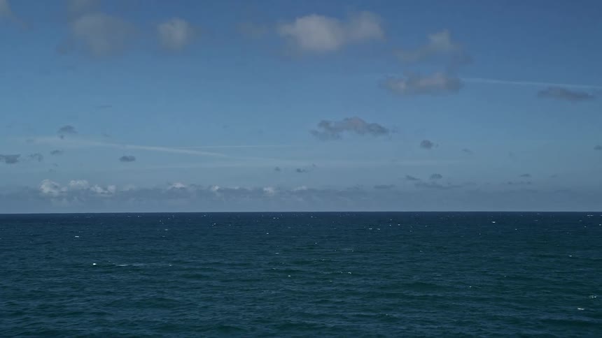 Aerial footage of Sunny Isles Beach Florida and the Atlantic Ocean with pockets of waves rippling in the open sea