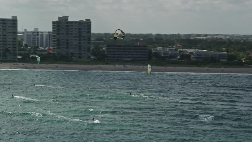 Kite surfers enjoy the sunny beach in Pompano Beach Florida in this stunning aerial footage