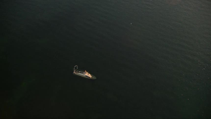 A stunning 4K aerial view of a sunken speedboat in Key Largo Florida at sunset