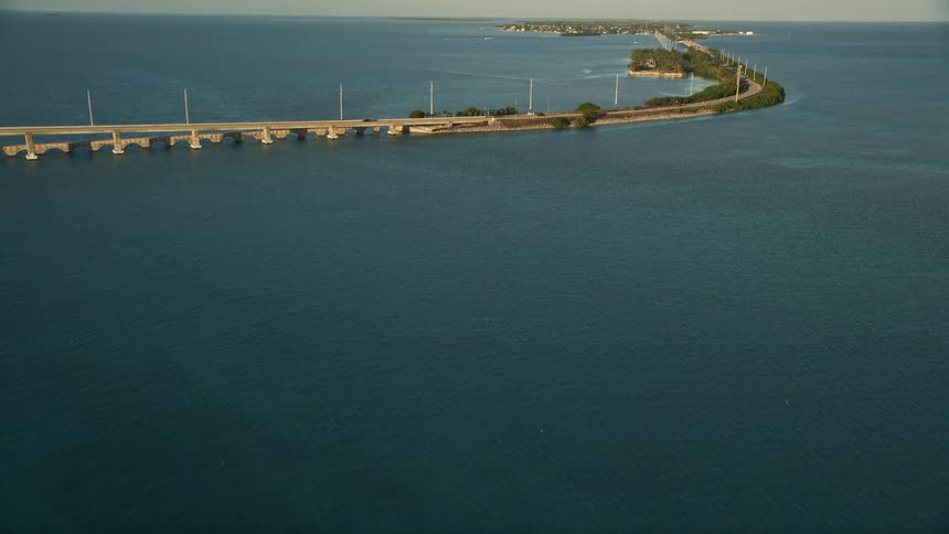 An aerial view of the Overseas Highway at sunset revealing the Florida Keys archipelago Craig Key and the Atlantic Ocean
