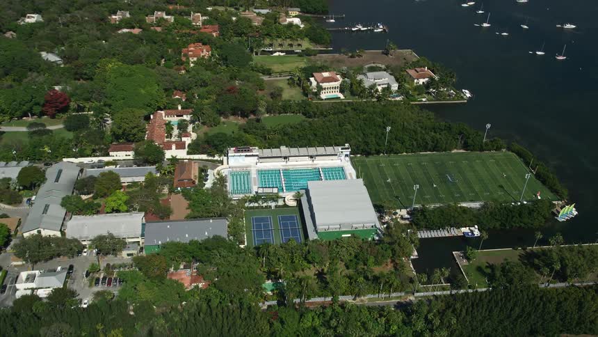 Approaching Ransom Everglades School in Coconut Grove this aerial view captures the sports fields and pools perfect for athletics and relaxation in southern Florida