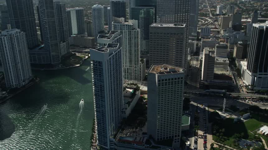 An aerial view of tall buildings along the waterfront in downtown Miami FL including the InterContinental Miami hotel and the Miami River captured during the spring or summer daytime
