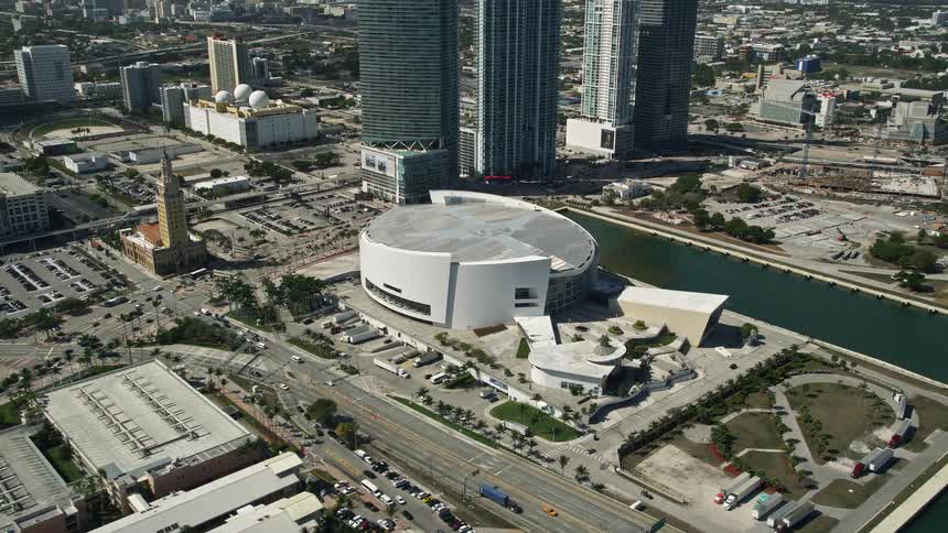 Approaching American Airlines Arena in Downtown Miami enjoy a stunning aerial view on a sunny day while basketball fans enter the arena