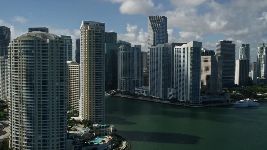 The camera takes a breathtaking aerial view of the towering skyscrapers located in downtown Miami set against the backdrop of a stunning coastline and bright sunshine - captured as part of Florida Coasts Aerials