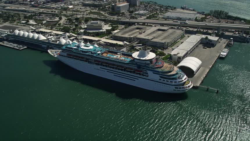 A stunning aerial view of a cruise ship docked at the Port of Miami Florida amidst a bustling harbor