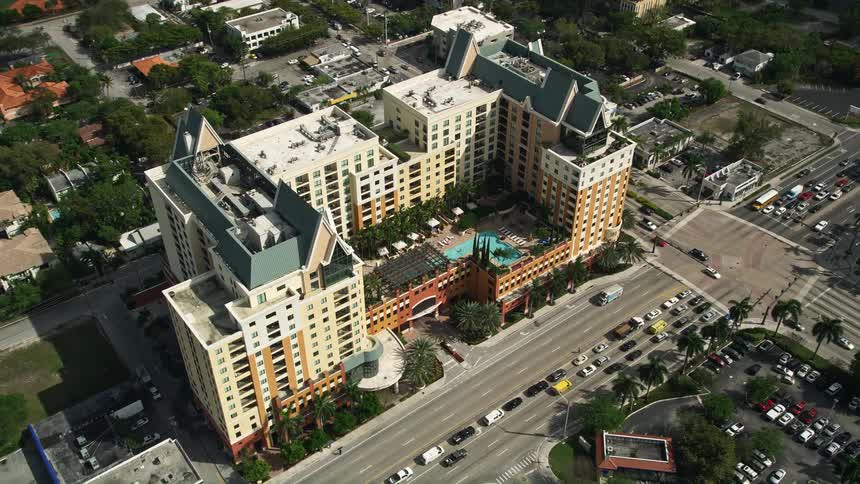Approaching condominium complex in Downtown Fort Lauderdale Florida viewed from above with a looking down as the camera tilts down to show the buildings pools