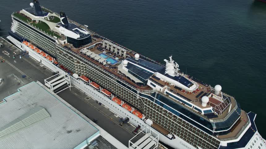 Aerial view of Celebrity Equinox cruise ship approaching the port of Everglades in Fort Lauderdale Florida on a partly cloudy day with tags including enjoyment tourism and luxury liner