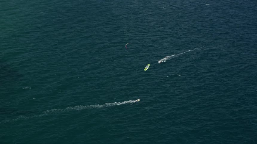 A stunning aerial view of kite surfers sailing in the ocean near Hillsboro Inlet Light Hillsboro Beach Florida capturing the thrill of extreme sports and leisure activity amidst the beautiful coastline transport travel and tourism