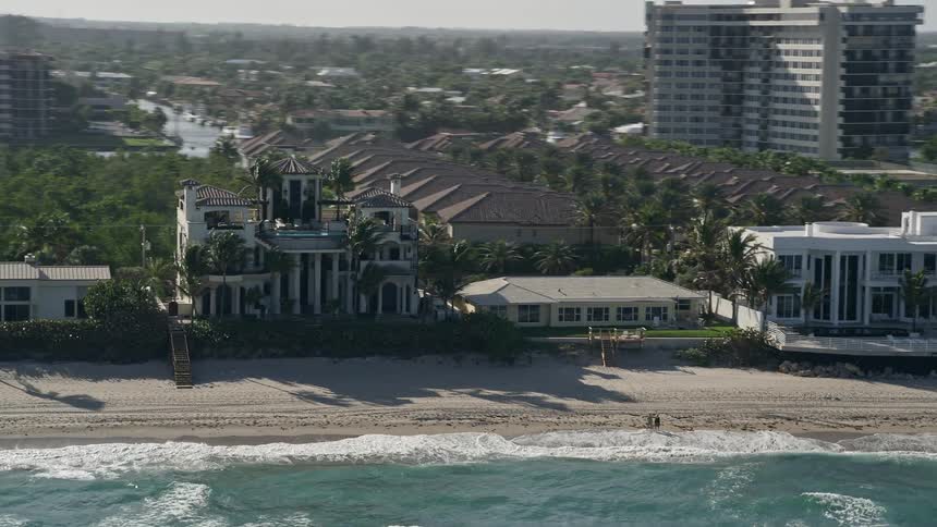 An aerial view of a luxurious mansion on the beach in Highland Beach Florida